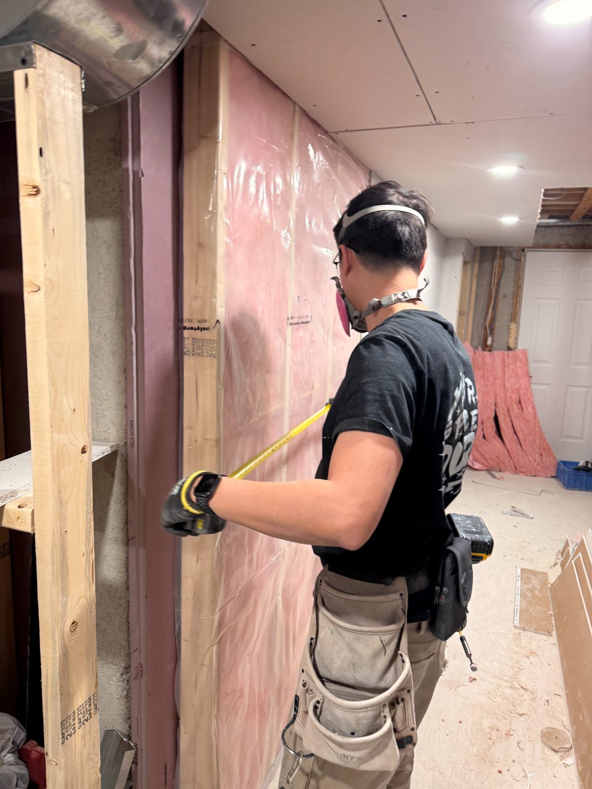 David Mok measuring a build on site